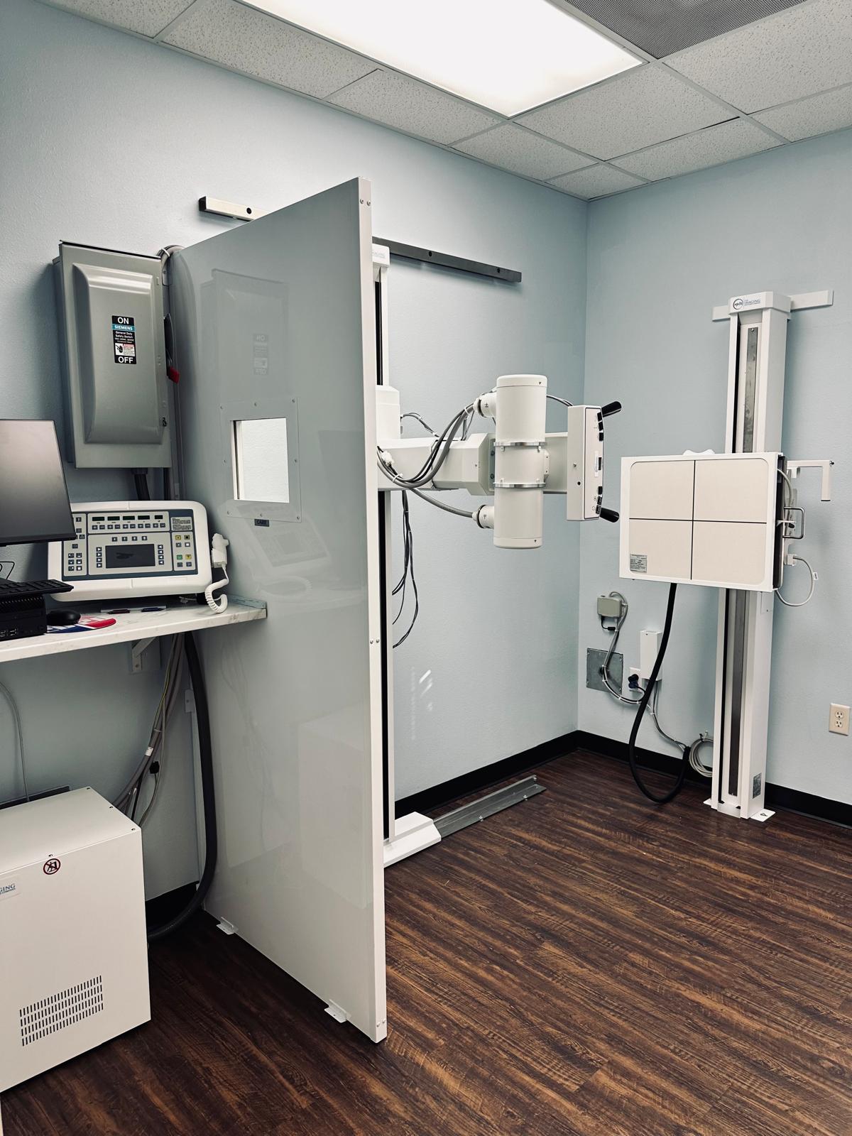 Advanced diagnostics imaging suite with digital radiography unit, control console, and protective shield at Atlas Injury to Health