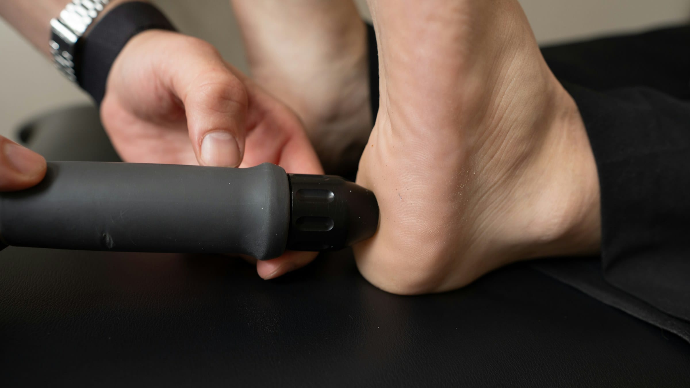 SoftWave therapy device applied to the heel, demonstrating FDA-cleared shockwave technology used to help Winter Garden athletes restore function in tendon and soft-tissue injuries without surgery.