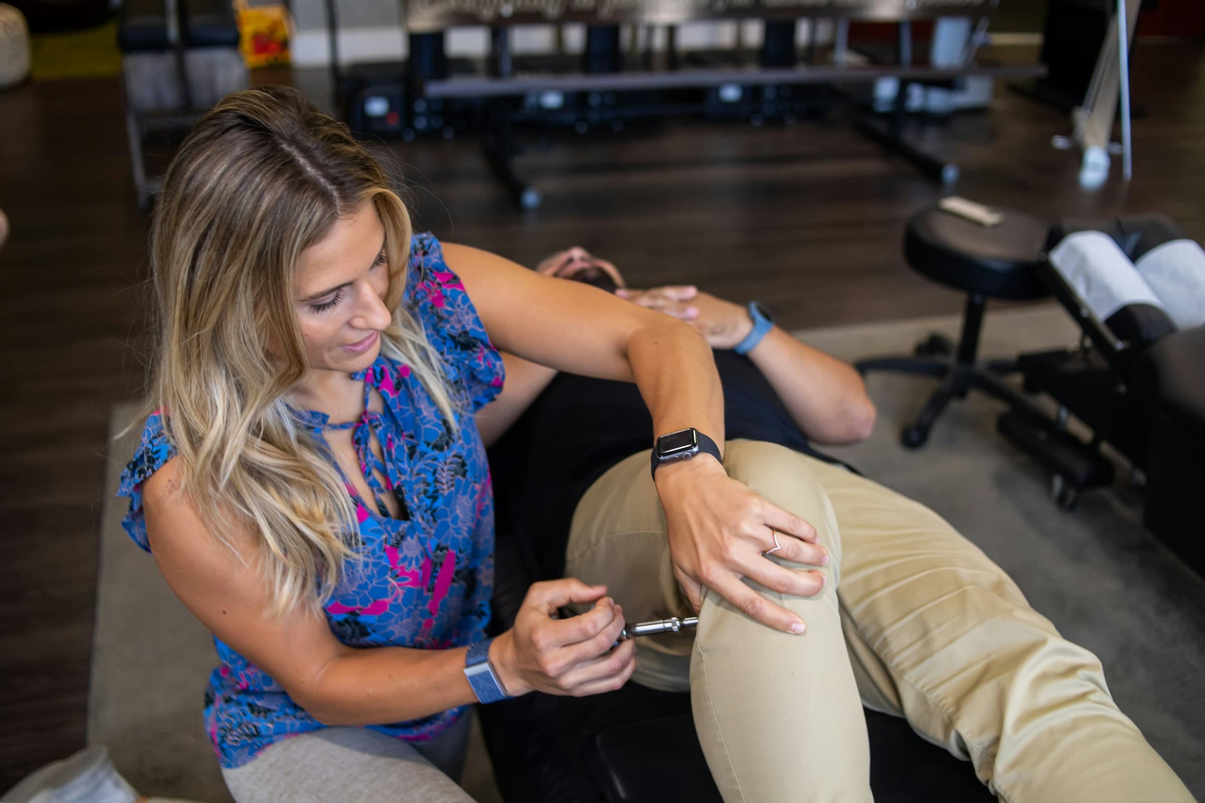 A clinician providing precision upper cervical care to a patient in a calm clinical setting, part of restoring function after whiplash-related injury.